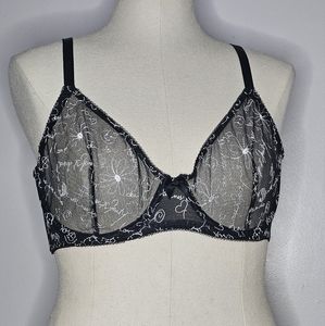 Unlined black mesh Savage Fenty bra with white embroidery pattern